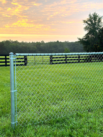 4foot galvanized chain link fence kit with light sunrise in background